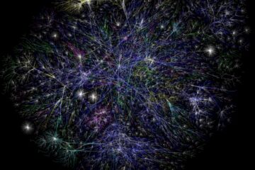 A complex, web-like network of colorful, branching lines against a black background, resembling a cosmic rhizome or an intricate root system. Fine threads in shades of blue, purple, green, yellow, and white intersect and diverge, creating a sprawling, interconnected structure. The image evokes the idea of decentralized connection, organic growth, and the infinite interlinking of individual paths into a collective whole.